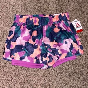 NWT Reebok purple and pink shorts with built in spandex undershorts